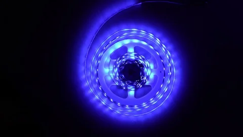 Led strip coil closeup. Diode shining stripe on dark blue background. Stock Footage 113010309