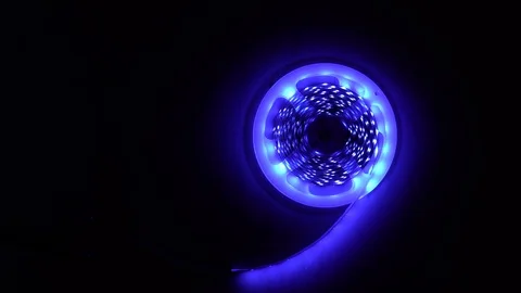 Led strip coil closeup. Diode shining stripe on dark blue background. Stock Footage 113010317