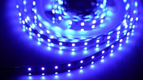 Led strip coil closeup. Diode shining stripe on dark blue background. Stock Footage 113010844
