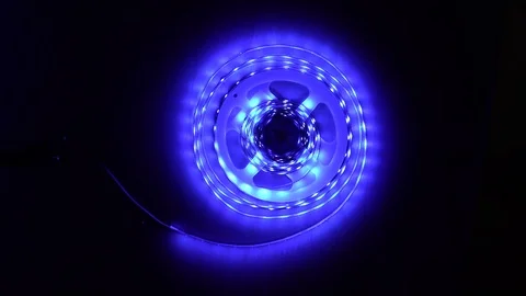 Led strip coil closeup. Diode shining stripe on dark blue background. Stock Footage 113011115