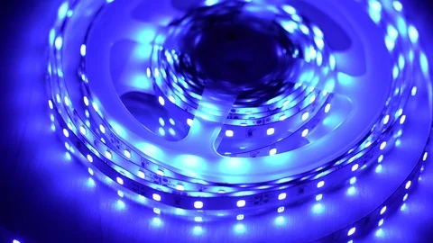 Led strip coil closeup. Diode shining stripe on dark blue background. Stock Footage 113011624