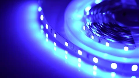 Led strip coil closeup. Diode shining stripe on dark blue background. Stock Footage 113011911