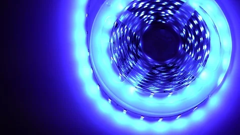 Led strip coil closeup. Diode shining stripe on dark blue background. Stock Footage 113012043
