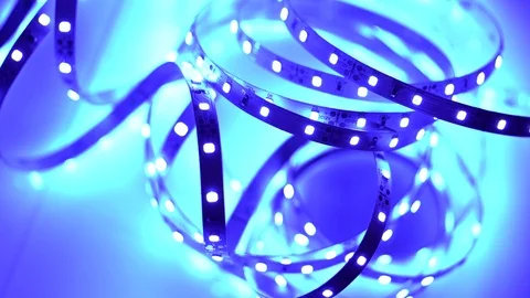 Led strip coil closeup. Diode shining stripe on dark blue background. Stock Footage 113012125