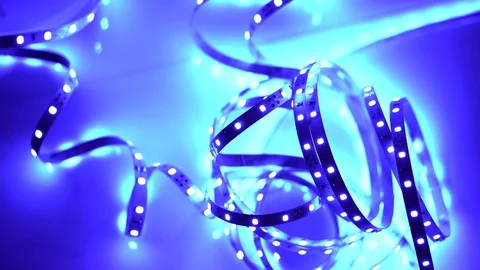 Led strip coil closeup. Diode shining stripe on dark blue background. Stock Footage 113012247