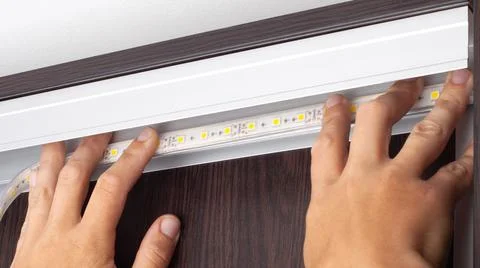 LED strip installation,master sets diode light line. Stock Photos