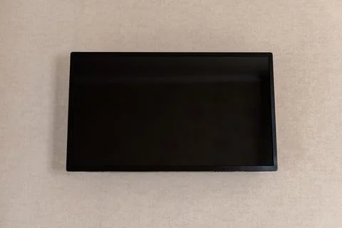 LED TV black screen on wall in hotel. Big flat screen. Power is turned off . Stock Photos
