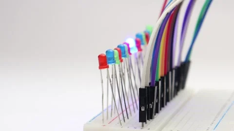 LED of various colors are glowing in order on a breadboard Stock Footage 339017808