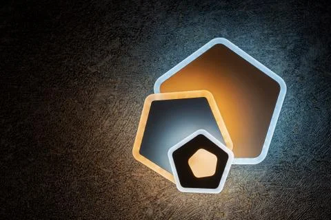 LED wall lights pentagonal form on a dark background. Stock Illustration