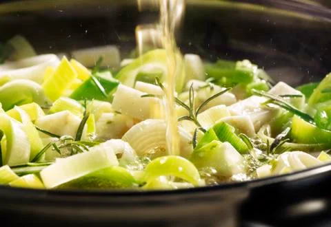 Leek being cooked in a pan Stock Photos