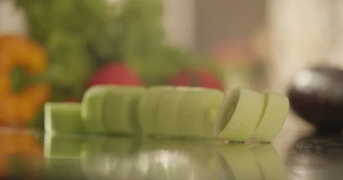 Leek slices fall on glass Stock Footage 200257397