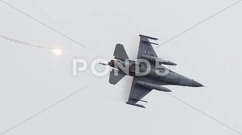 LEEUWARDEN, THE NETHERLANDS - JUN 11, 2016: Dutch F-16 fighter jet firing off Stock Photos