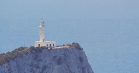 Lefkada lighthouse on Cape Doukato cliff waving in the heat of the summer Stock Footage 298929265