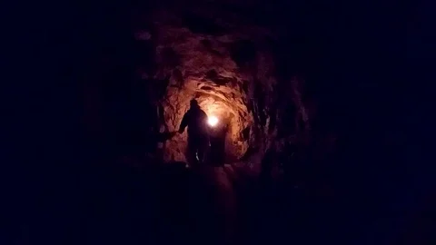 Left in cave. Person with tourch Stock Footage