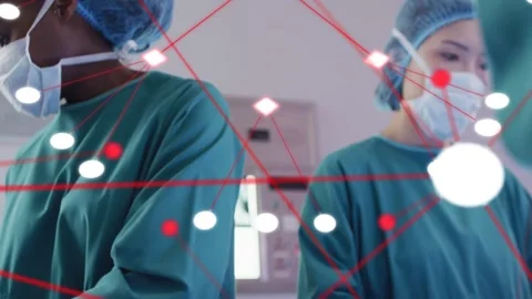 Left clinician handing forceps to peer during surgery, red node overlay 스톡 동영상 333221049