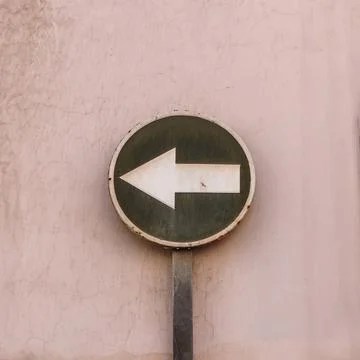 Left Direction Sign on Wall Stock Photos
