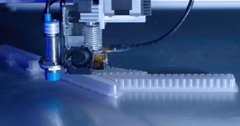 Left dolly close up on 3 D printer nozzle making production parts, Video stock 108404914