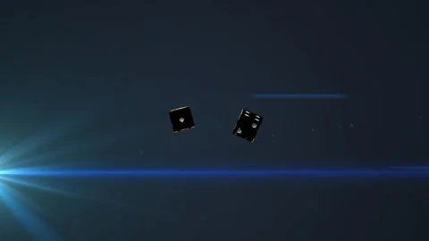 Left flare glowing causing pair black dice tumbling settling showing gold Stock Footage 340674889