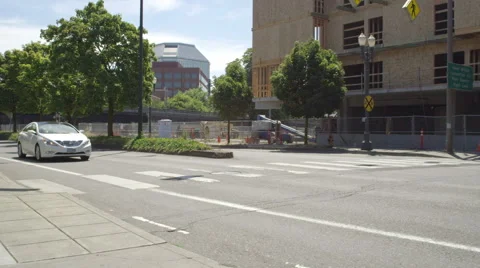 Left Front Three Quarter view of a Driving Plate: Car turns right onto NW Naito Stock Footage 59309058