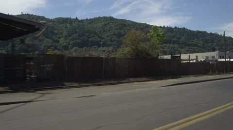 Left Front Three Quarter view of a Driving Plate; Car travels on NW Front Avenue Stock Footage 59310862