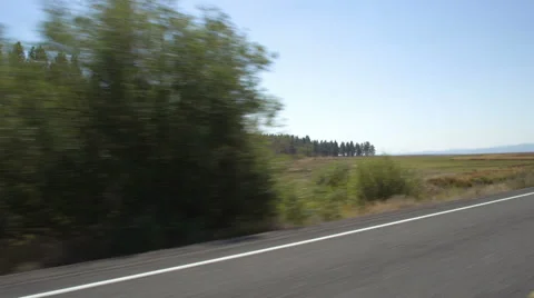 Left Front Three Quarter view of a Driving Plate: Car travels south on Silver Stock Footage 59512538