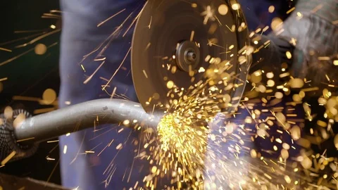 The Left Gloved Hand Saws Grinder Pipe Sparks Fly Can See His Feet in Blue Vídeos de archivo 72090880