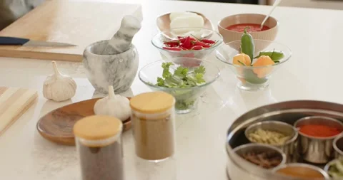 Left hand is entering and resting on kitchen counter by marble mortar, starting Stock Footage 335199498