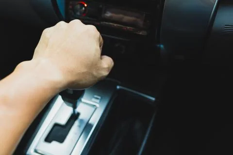 The left hand man is shifting the automatic car gear Stock Photos