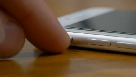 Left hand that puts the smartphone in silent mode Stock Footage 87378927