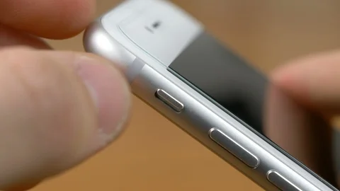 Left hand that puts the smartphone in silent mode Stock Footage 87378962