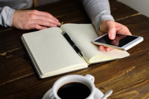 Left hander woman using her smartphone Stock Photos
