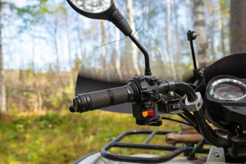 Left handle of an ATV, windshield, and rear view mirrors. Quad bike or ATV Stock Photos