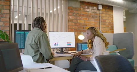 Left male starting by gesturing at charts right woman pointing third joining Stock Footage 337944511