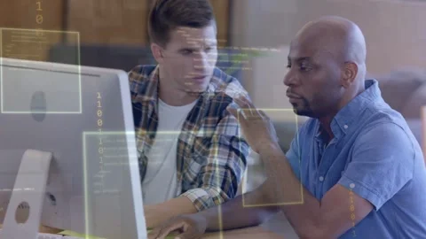 Left man pointing and typing right man nodding and gesturing initiating tech Stock Footage 335235563