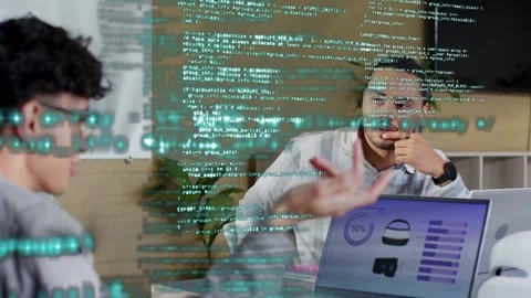 Left man pointing laptop charts, right man nodding, starting data review, code Stock Footage 333105778