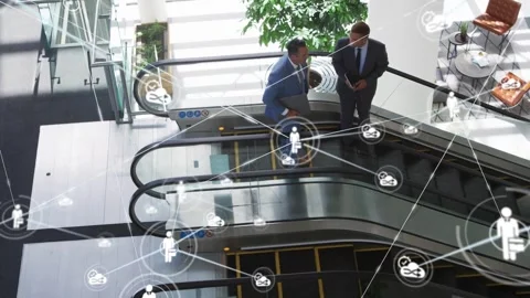Left man stepping toward right man gesturing with tablet, node overlay spreading Video stock 334036820