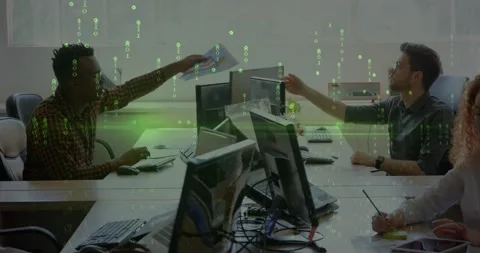 Left office staff handing paper causing peer reaching over screens to check; Stock Footage 333901081
