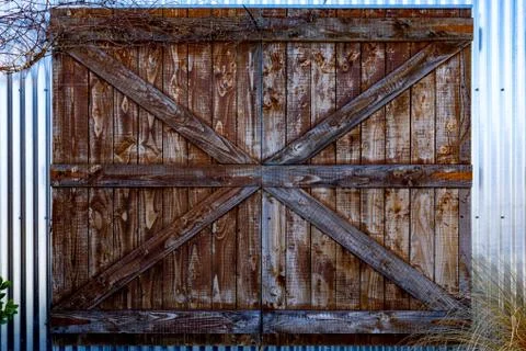 A Left Old Rustic Barn Door on a TIn Shed Stock Photos