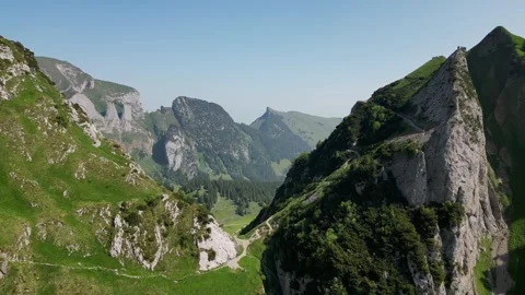 Left Orbit Over Alpine Ridge and Valley Trail Saxer Lucke Stock Footage 323331299
