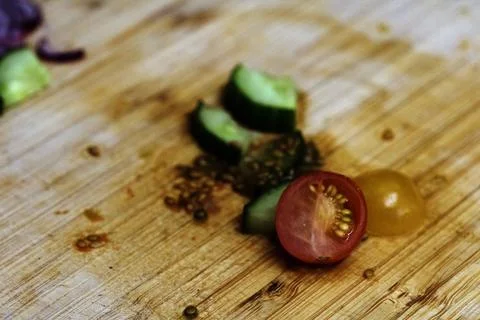 Left over salad from dinner chopped cucumber tomato onion food waste on cho.. Stock Photos