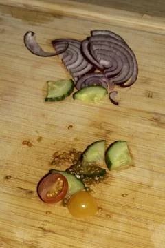 Left over salad from dinner chopped cucumber tomato onion food waste on cho.. Stock Photos