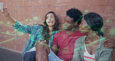 Left pal taking selfie group sharing phone showing post laughing under green net Stock Footage 328246155