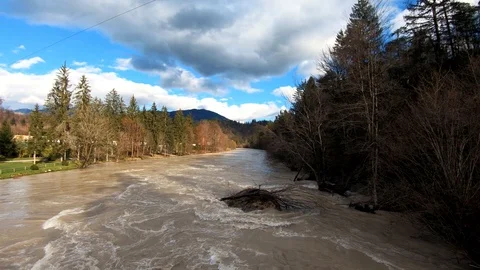 Left pan aerial view rapid wild brown flooded river Stock Footage 121513768