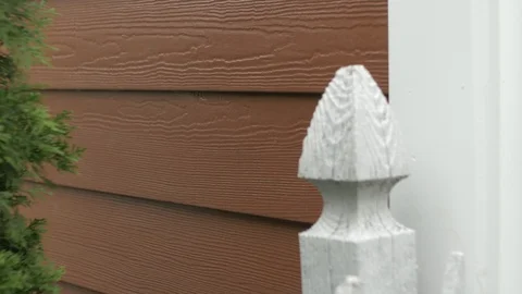 Left Pan of Red Siding and Green Foliage Video stock 100899296