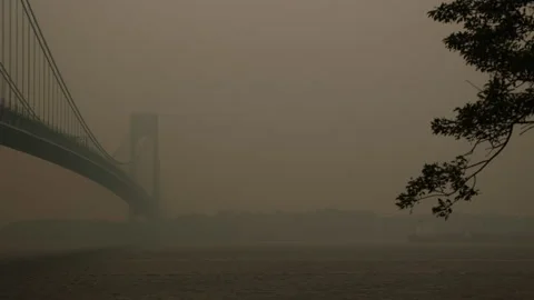 Left Pan Shot Smoke of Engulfed Verrazano Bridge. Bay Ridge Brooklyn. Stock Footage 243229037