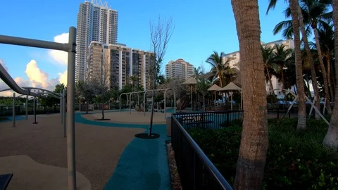 Left pan view of child playground at dusk, Miami Beach Stock Footage 114636528