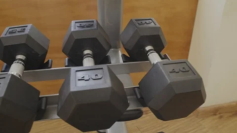 LEFT PANNING OVER WEIGHTS OF 25 LBS IN A GYM Stock Footage 107290828