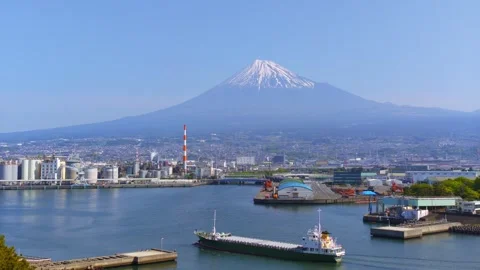 Left panning shot of Mt. Fuji and Tagonoura Port with Ship Stock Footage 334679349