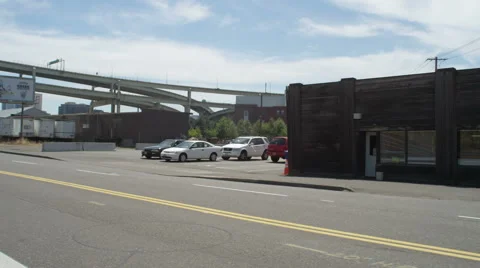 Left Rear Three Quarter view of a Driving Plate: Car travels on NW Front Avenue Stock Footage 59309696