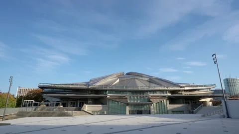Left to right 4k pan shot of the Tokyo Metropolitan Gymnasium on a bright Stock Footage 141138991